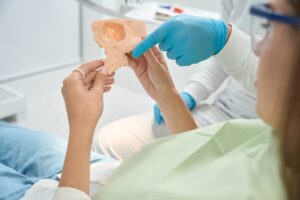 dentist in Katy TX demonstrating cracked tooth treatment options during a consultation