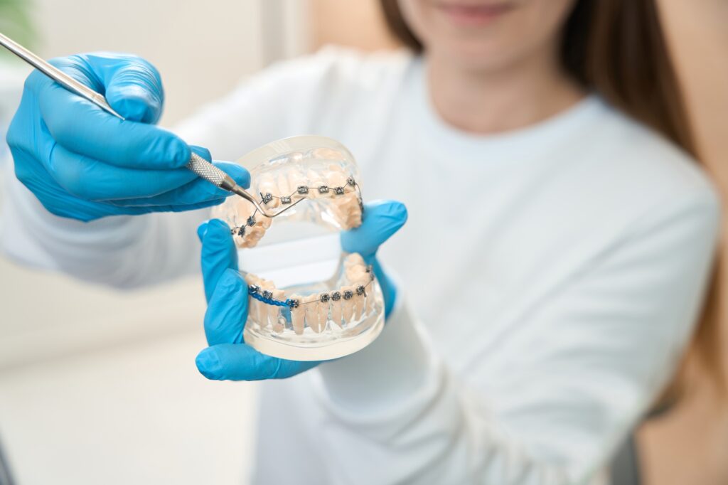 dentist in Katy TX comparing Invisalign aligners and traditional braces during consultation
