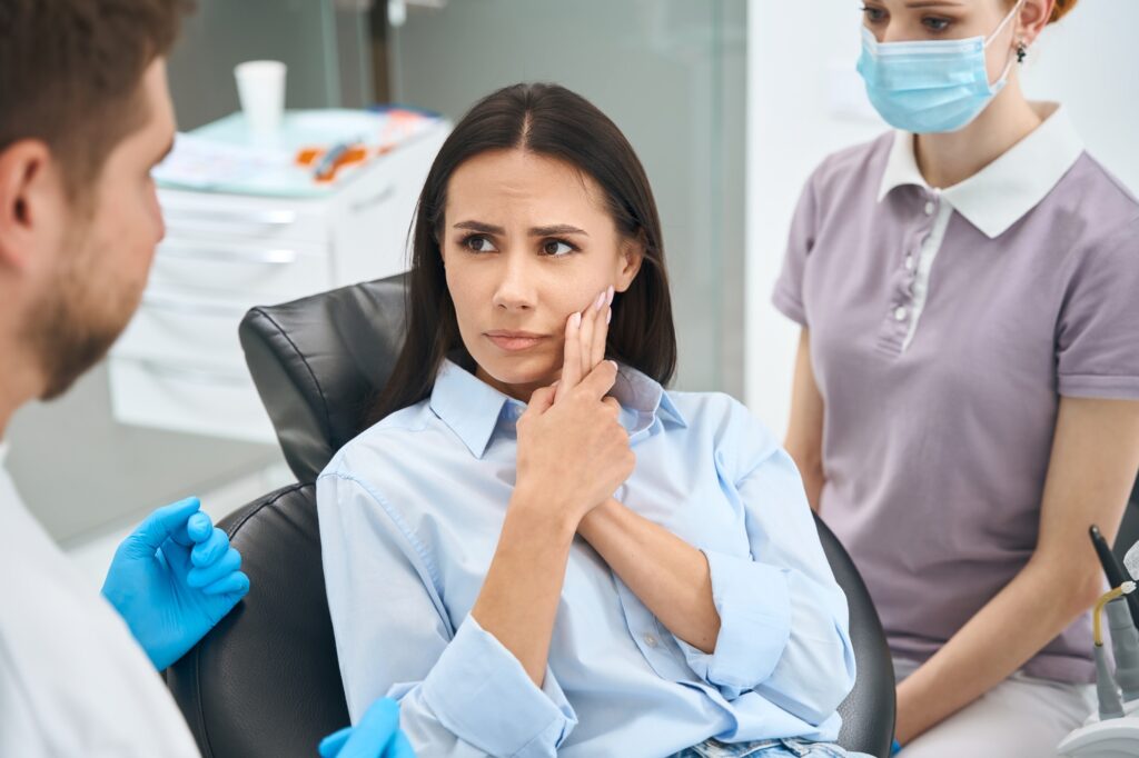 dentist in Katy TX examining patient with toothache during dental exam