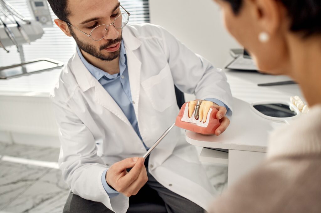 dentist in Katy TX discussing dental implant and denture options for missing tooth