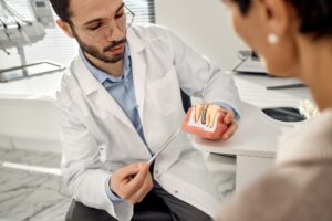 dentist in Katy TX discussing dental implant and denture options for missing tooth