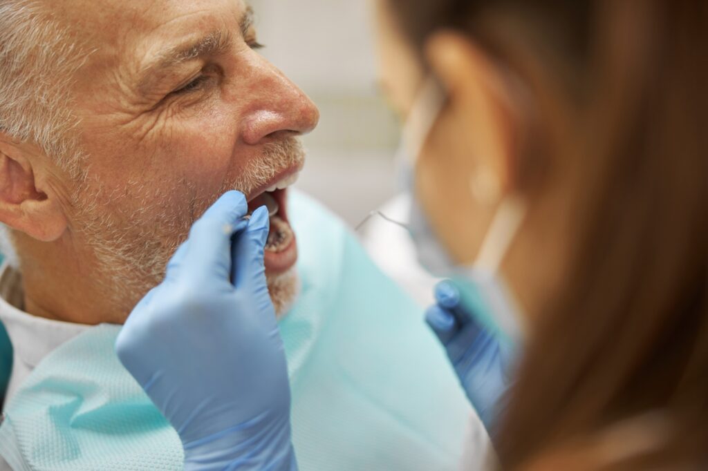 emergency dentist in Katy TX examining patient with tooth pain