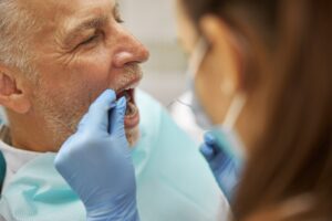 emergency dentist in Katy TX examining patient with tooth pain