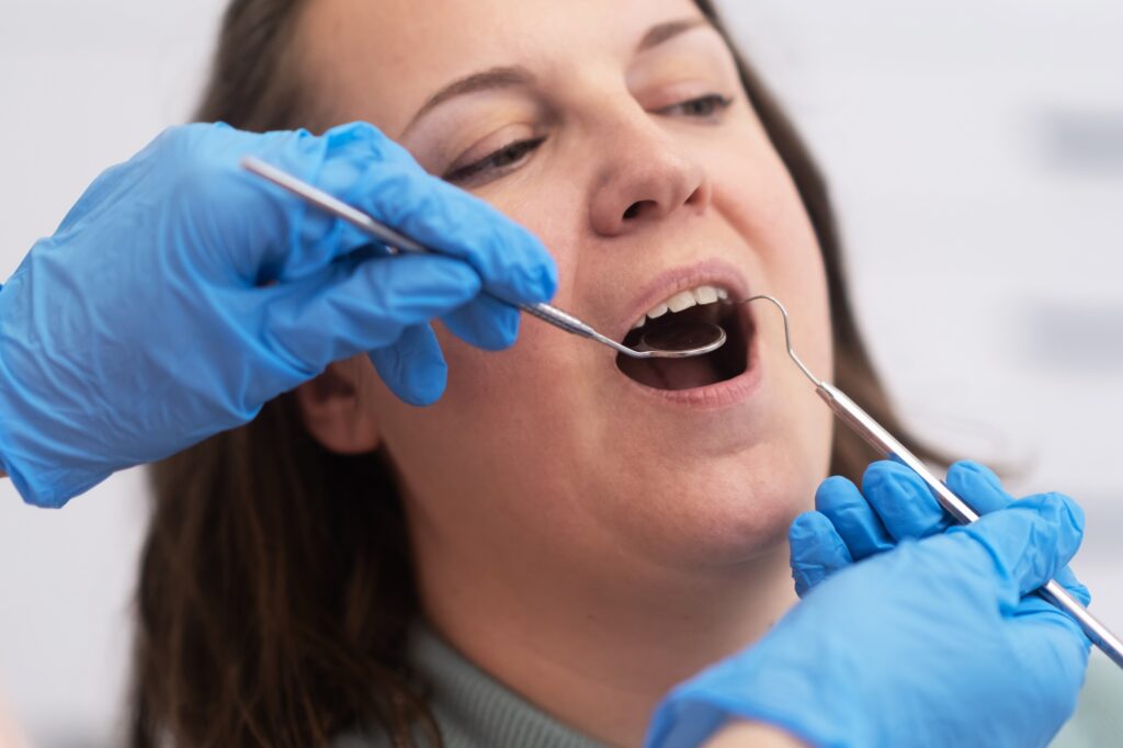 dentist in Katy TX performing gum disease evaluation during dental exam