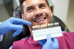 dentist in Katy TX showing porcelain veneer treatment options to patient