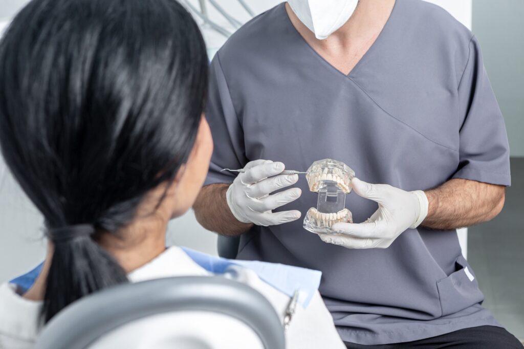 dentist in Katy TX explaining dental crowns and bridges during consultation