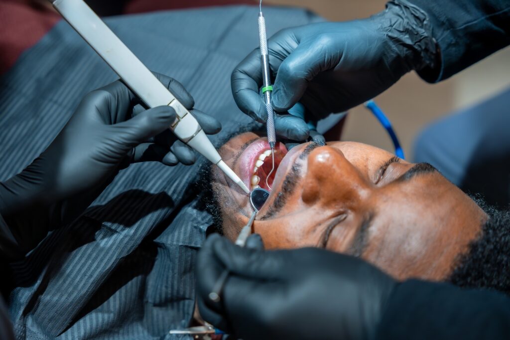 Dentist examining a cracked tooth in a patient from Katy TX