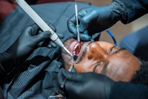 Dentist examining a cracked tooth in a patient from Katy TX